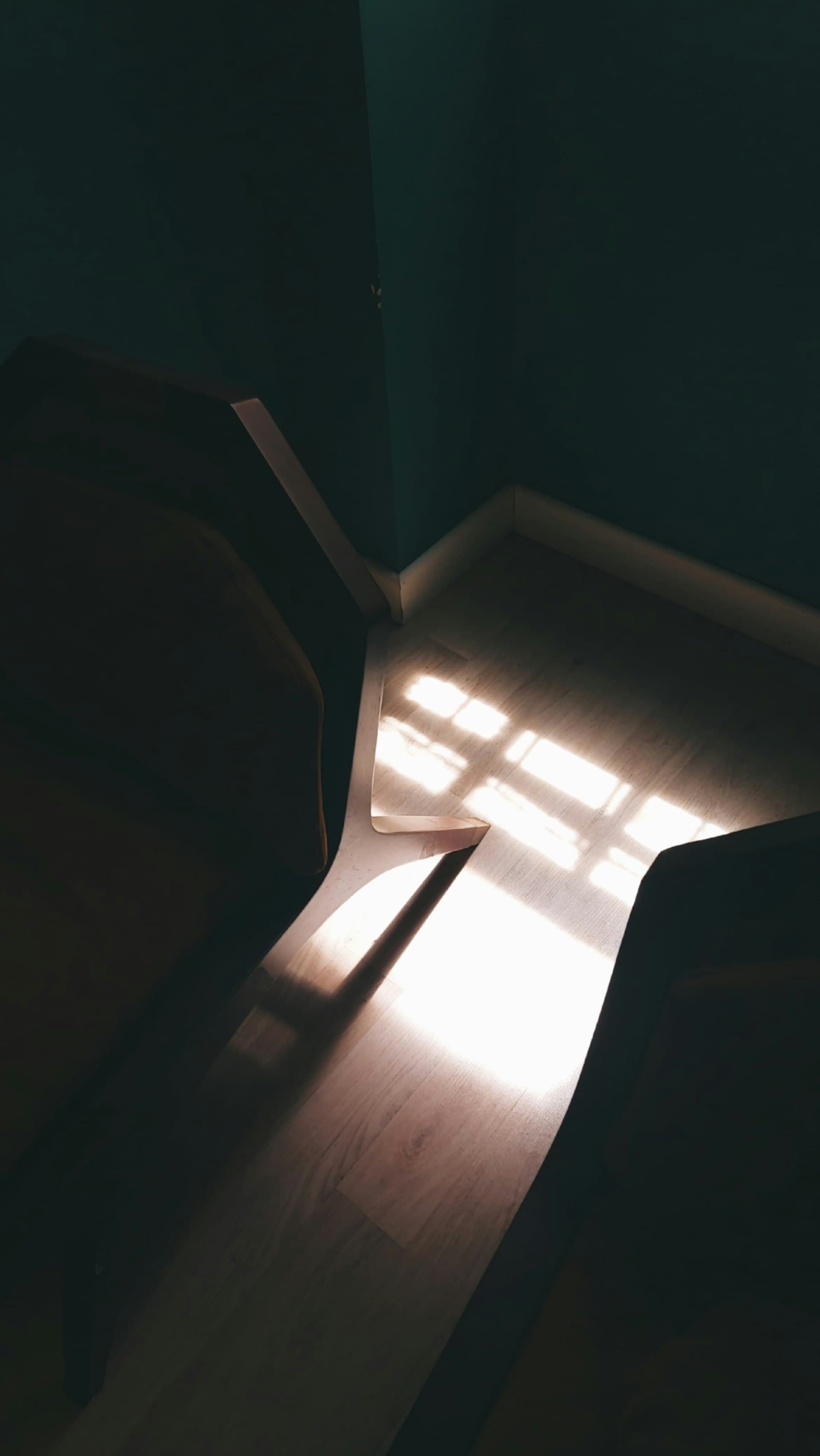 Warm sunlight streaming through a window onto a wooden floor — imagery of openness and trust